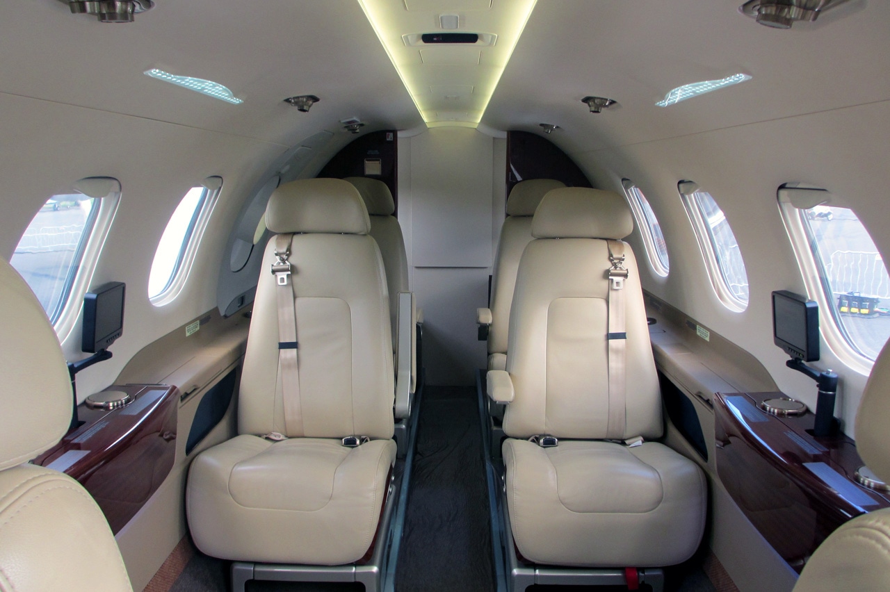 Phenom 300 charter private jet cabin interior thumbnail 3