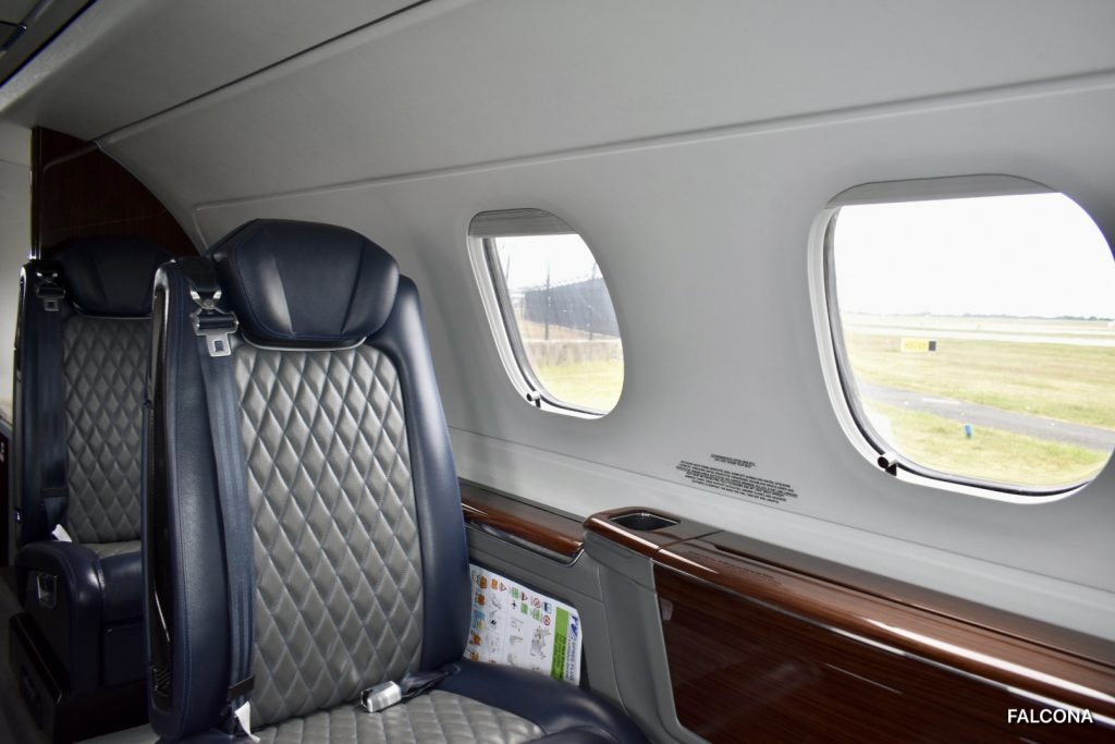 Phenom 300E charter private jet cabin interior photo 1 of 4